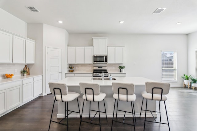 13412 Cortes De Pallas Dr, Little Elm, TX 75068 - kitchen featuring stainless steel appliances, a kitchen island with sink, a kitchen breakfast bar, backsplash, and recessed lighting