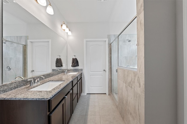 bathroom with a sink, tile patterned floors, and a stall shower