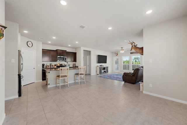 living room featuring visible vents, ceiling fan, recessed lighting, and baseboards