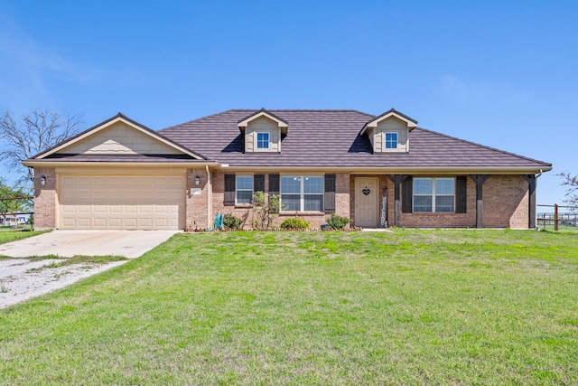 view of front of property featuring a garage, brick siding, driveway, and a front lawn