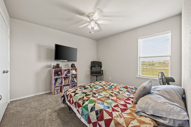 carpeted bedroom with baseboards and a ceiling fan
