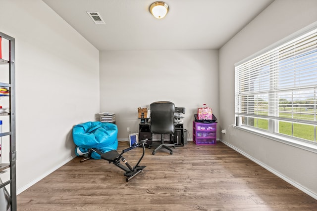 office featuring visible vents, baseboards, and wood finished floors