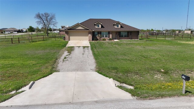 view of front of house with a front lawn, fence, an attached garage, and concrete driveway