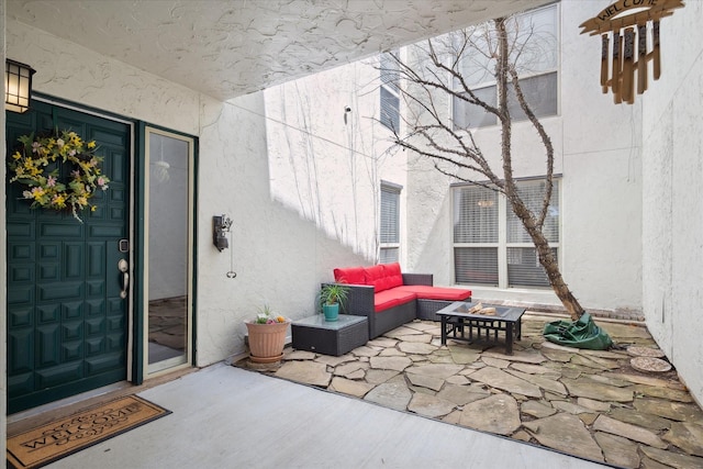 12550 Burninglog Ln, Dallas, TX 75243 - doorway to property featuring a patio, an outdoor living space, and stucco siding