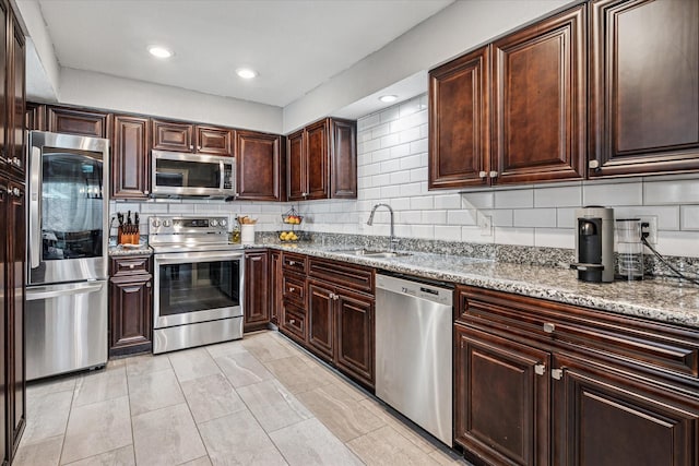 12550 Burninglog Ln, Dallas, TX 75243 - kitchen featuring a sink, decorative backsplash, dark brown cabinetry, and stainless steel appliances