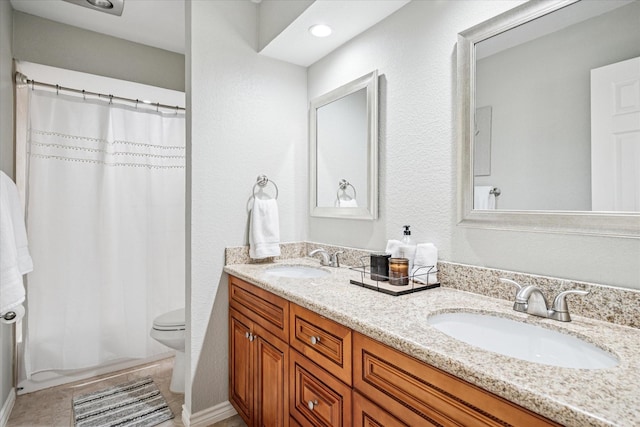 12550 Burninglog Ln, Dallas, TX 75243 - bathroom featuring double vanity, a sink, toilet, and a shower with curtain