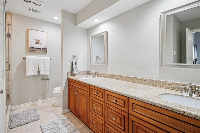 12550 Burninglog Ln, Dallas, TX 75243 - full bathroom with a sink, toilet, double vanity, and visible vents
