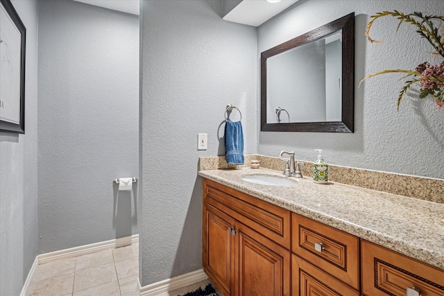 12550 Burninglog Ln, Dallas, TX 75243 - bathroom featuring baseboards, a textured wall, tile patterned flooring, and vanity