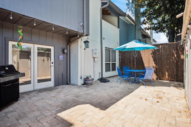 12550 Burninglog Ln, Dallas, TX 75243 - view of patio featuring french doors, fence, and outdoor dining area