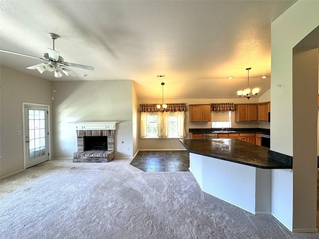 132 Yosemite Ln, Terrell, TX 75160 - kitchen featuring dark countertops, brown cabinets, a sink, dark carpet, and a chandelier