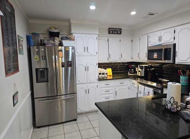 221 Azalea Dr, Sulphur Springs, TX 75482 - kitchen with stainless steel appliances, white cabinets, light tile patterned flooring, backsplash, and ornamental molding