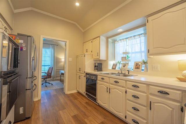 kitchen with vaulted ceiling, ornamental molding, black appliances, a sink, and wood finished floors