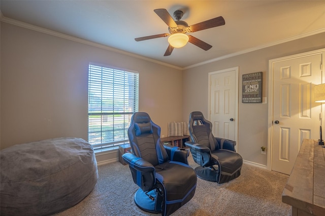 living area featuring ornamental molding, baseboards, a ceiling fan, and carpet flooring
