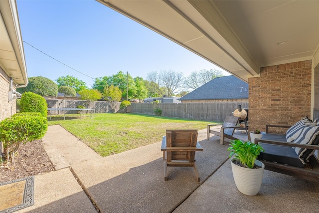 view of patio / terrace featuring a trampoline and a fenced backyard