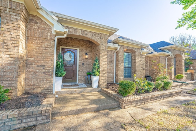 property entrance featuring brick siding