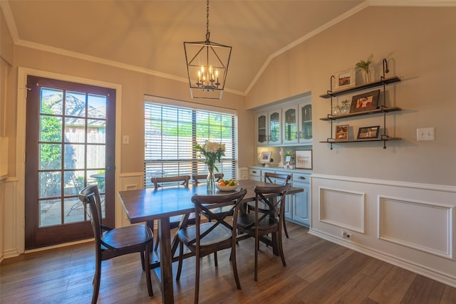 dining area featuring crown molding, a notable chandelier, and lofted ceiling