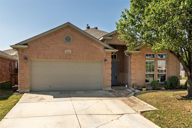 2100 Carlotta Dr, Fort Worth, TX 76177 - ranch-style home featuring an attached garage, brick siding, driveway, and a front yard