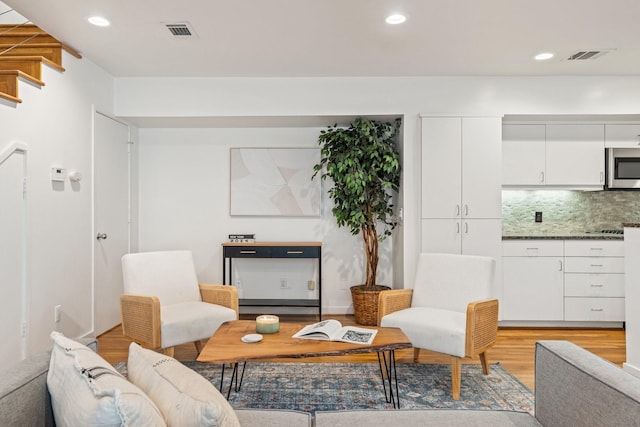 4122 Travis St Unit 7, Dallas, TX 75204 - living room featuring light wood-type flooring and recessed lighting
