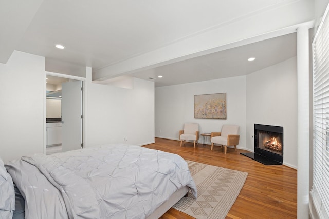 4122 Travis St Unit 7, Dallas, TX 75204 - bedroom with wood finished floors, a lit fireplace, and recessed lighting