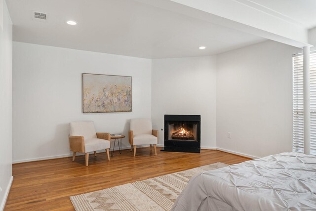 4122 Travis St Unit 7, Dallas, TX 75204 - bedroom with wood finished floors, a fireplace with flush hearth, and recessed lighting