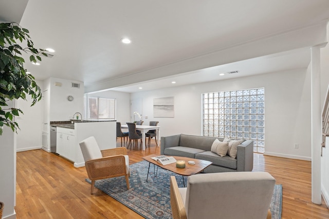 4122 Travis St Unit 7, Dallas, TX 75204 - living room featuring healthy amount of natural light, light wood-style flooring, baseboards, and recessed lighting