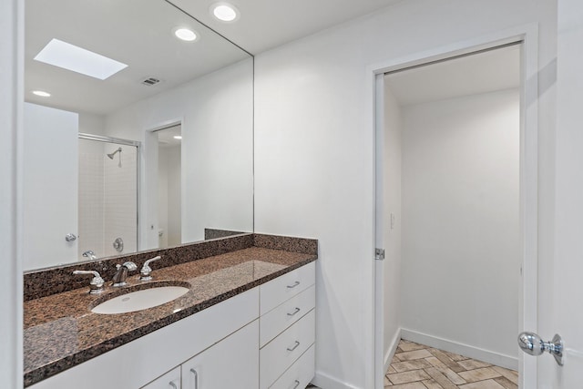 4122 Travis St Unit 7, Dallas, TX 75204 - full bath featuring a skylight, vanity, a shower with shower door, and recessed lighting