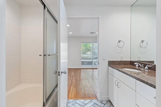 4122 Travis St Unit 7, Dallas, TX 75204 - full bath featuring vanity, enclosed tub / shower combo, wood finished floors, and recessed lighting