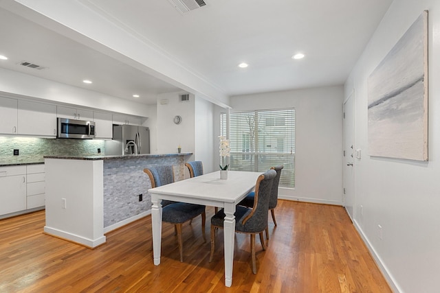 4122 Travis St Unit 7, Dallas, TX 75204 - dining space with light wood-style flooring and recessed lighting