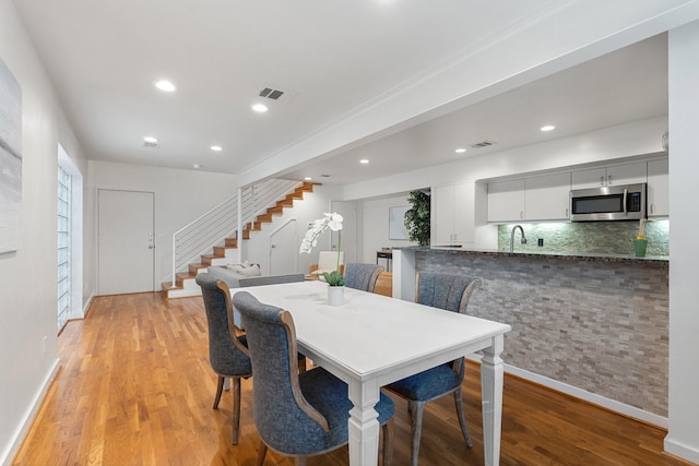 4122 Travis St Unit 7, Dallas, TX 75204 - dining space with stairway, light wood-style floors, and recessed lighting