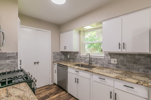 kitchen featuring dishwasher, white cabinetry, a sink, and range with gas cooktop