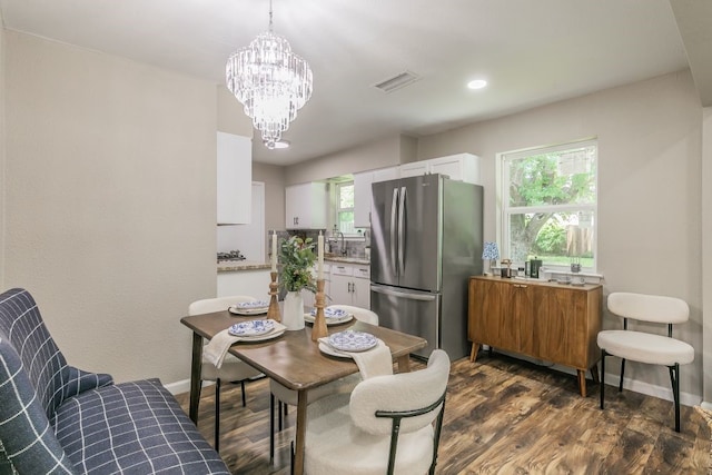 1807 Lachelle Ln, Arlington, TX 76010 - dining space featuring a chandelier, healthy amount of natural light, dark wood-type flooring, and baseboards