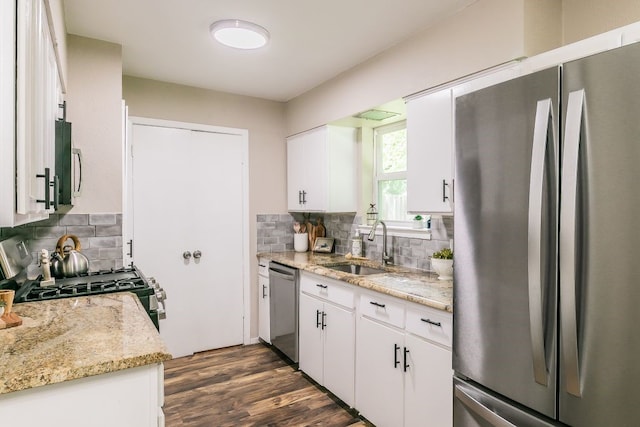 1807 Lachelle Ln, Arlington, TX 76010 - kitchen featuring appliances with stainless steel finishes, a sink, backsplash, white cabinetry, and dark wood-style floors