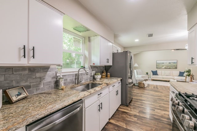 1807 Lachelle Ln, Arlington, TX 76010 - kitchen featuring stainless steel appliances, a sink, white cabinetry, light stone countertops, and dark wood-style floors