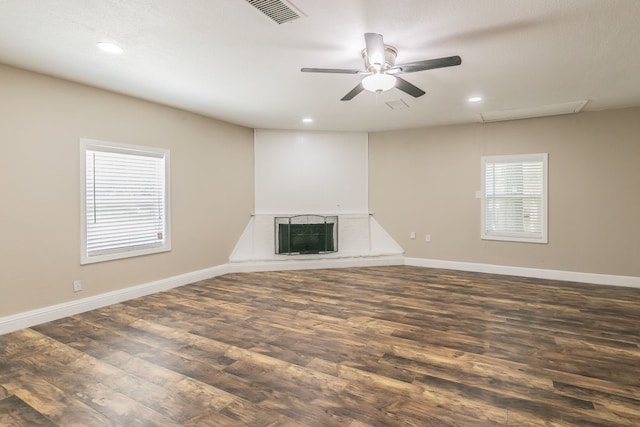 1807 Lachelle Ln, Arlington, TX 76010 - unfurnished living room featuring a fireplace with raised hearth, dark wood finished floors, recessed lighting, and baseboards