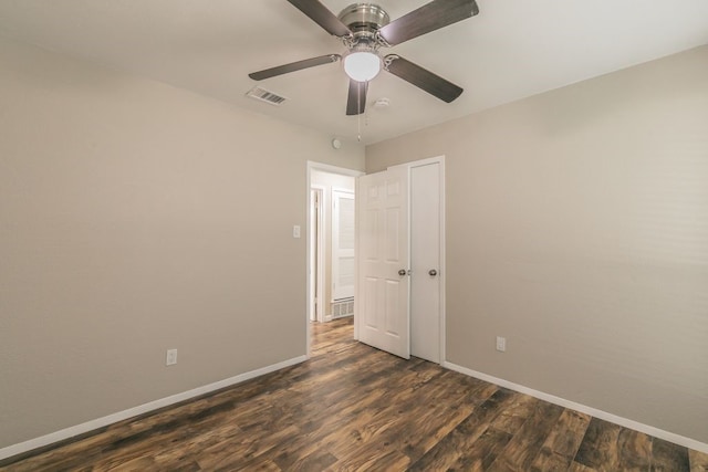 1807 Lachelle Ln, Arlington, TX 76010 - unfurnished bedroom with baseboards, dark wood-style floors, and a ceiling fan
