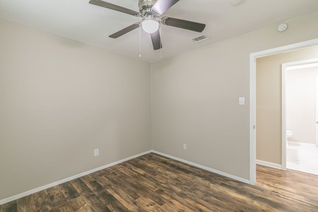 1807 Lachelle Ln, Arlington, TX 76010 - unfurnished room with dark wood finished floors, baseboards, a ceiling fan, and a smoke detector