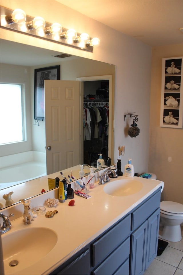 12824 Kingsgate Dr, Rhome, TX 76078 - bathroom with double vanity, a sink, tile patterned flooring, and a spacious closet