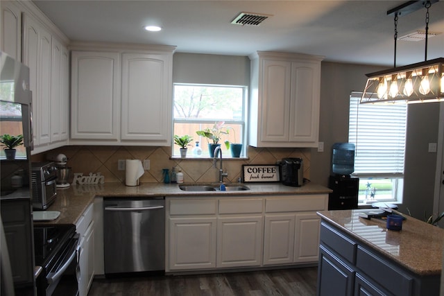 12824 Kingsgate Dr, Rhome, TX 76078 - kitchen with stainless steel dishwasher, visible vents, dark wood-style flooring, a sink, and electric stove