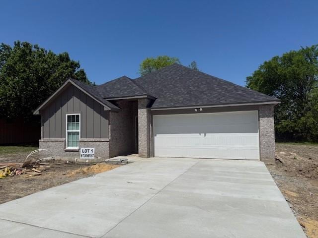 ranch-style home with brick siding, driveway, board and batten siding, and an attached garage