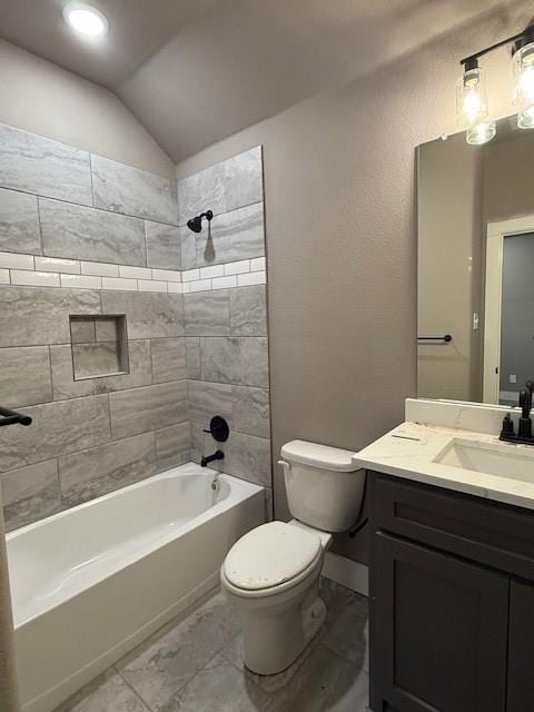 full bathroom featuring toilet, tub / shower combination, vanity, vaulted ceiling, and marble finish floor