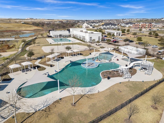 community pool featuring a patio and fence