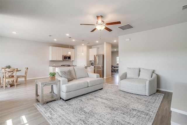628 Bronze Forest Dr, Fort Worth, TX 76131 - living room featuring ceiling fan, light wood finished floors, baseboards, and recessed lighting