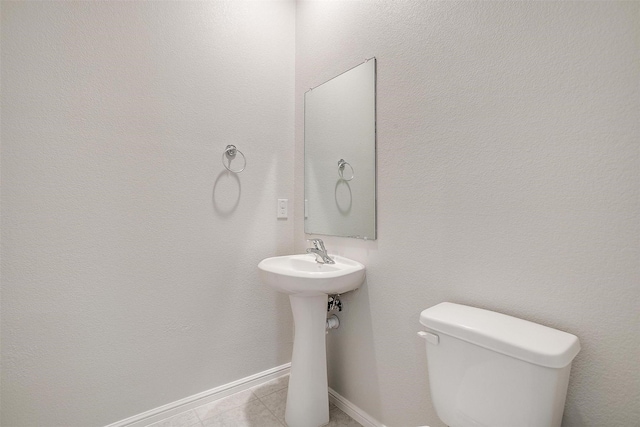 628 Bronze Forest Dr, Fort Worth, TX 76131 - half bath with toilet, baseboards, tile patterned floors, and a sink