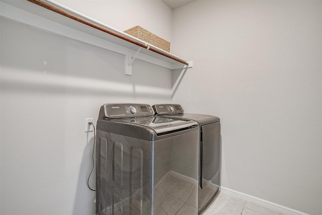 628 Bronze Forest Dr, Fort Worth, TX 76131 - laundry area with washing machine and dryer, light tile patterned floors, and baseboards