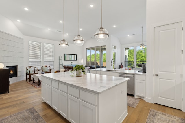 808 Bluestem Dr, Aubrey, TX 76227 - kitchen with open floor plan, a sink, a center island, stainless steel dishwasher, and vaulted ceiling