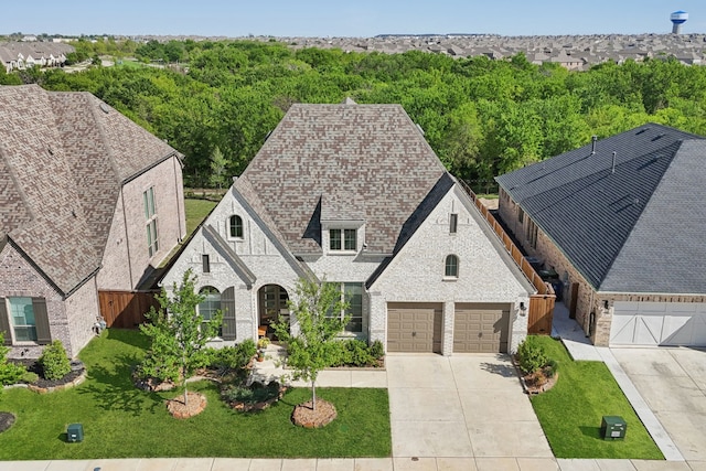 808 Bluestem Dr, Aubrey, TX 76227 - french country inspired facade with driveway, a garage, brick siding, and roof with shingles