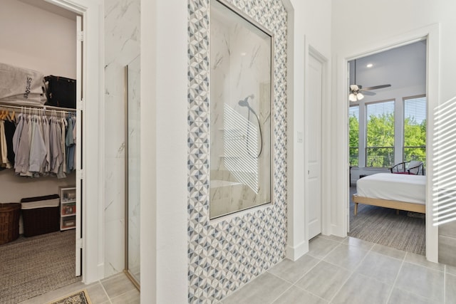 808 Bluestem Dr, Aubrey, TX 76227 - full bathroom featuring walk in shower, ensuite bathroom, ceiling fan, tile patterned flooring, and a spacious closet