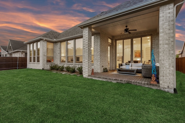 808 Bluestem Dr, Aubrey, TX 76227 - back of house at dusk featuring brick siding, a ceiling fan, an outdoor hangout area, a patio area, and a shingled roof