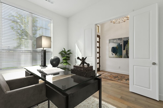 808 Bluestem Dr, Aubrey, TX 76227 - office area featuring a chandelier, wood finished floors, and baseboards