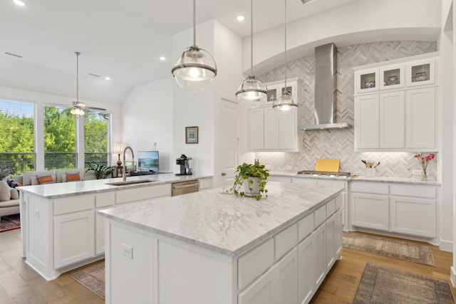 808 Bluestem Dr, Aubrey, TX 76227 - kitchen with a sink, wall chimney range hood, a kitchen island, dishwasher, and decorative backsplash